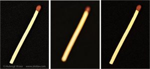 Three pictures of a match in and out of focus using different aperture sizes.